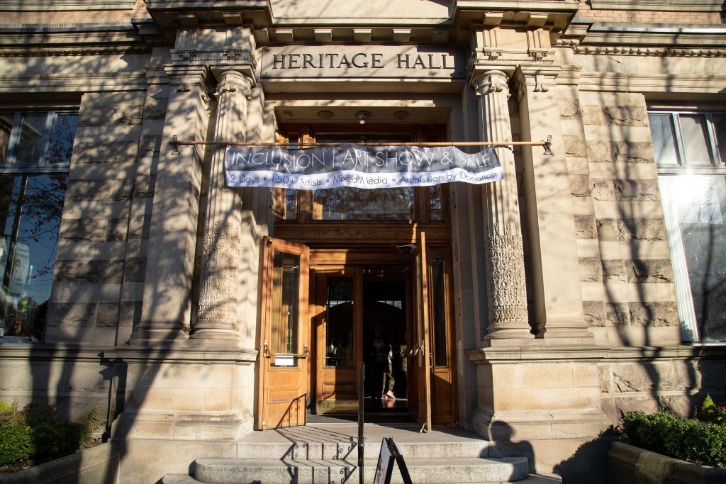 The front Heritage Hall, with the Inclusion Art Show banner hanging over the door.