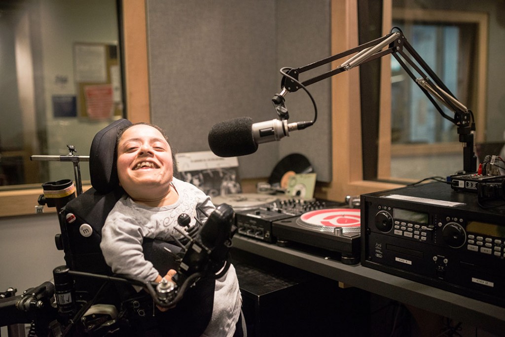 Deepi Leihl at a microphone in the radio studio