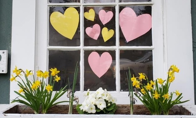 Pink and yellow hearts in a window