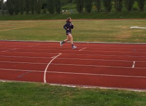 A woman runs on a track